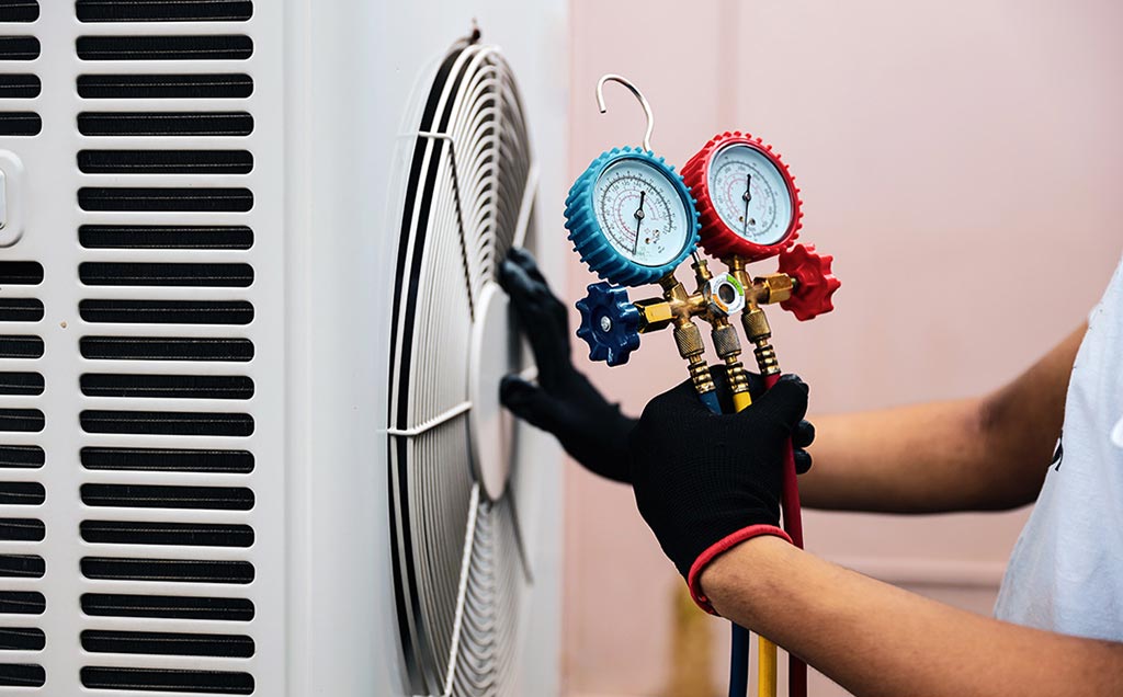 HVAC service repairman checking air conditioner